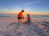 Imogene playing in the sand on the beach.